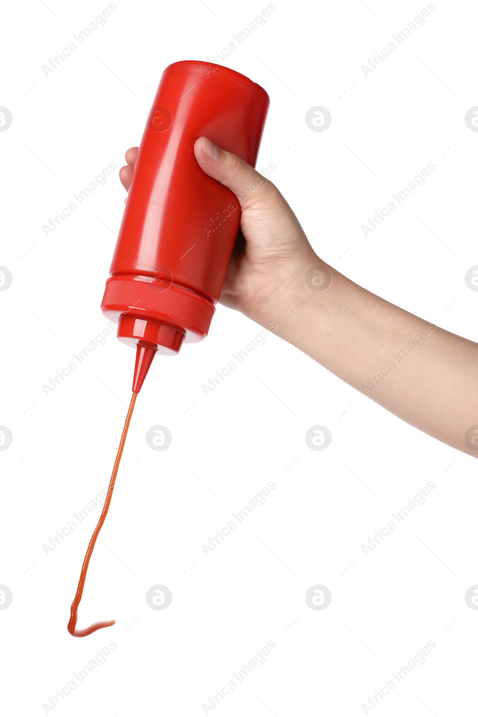 Photo of Woman pouring tasty ketchup from bottle on white background, closeup