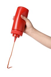 Woman pouring tasty ketchup from bottle on white background, closeup