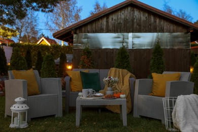Photo of Comfortable rattan furniture and beautiful autumn decor on backyard
