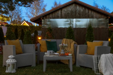 Comfortable rattan furniture and beautiful autumn decor on backyard