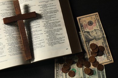 Donate and give concept. Coins, dollar banknotes, cross and Bible on dark table, flat lay
