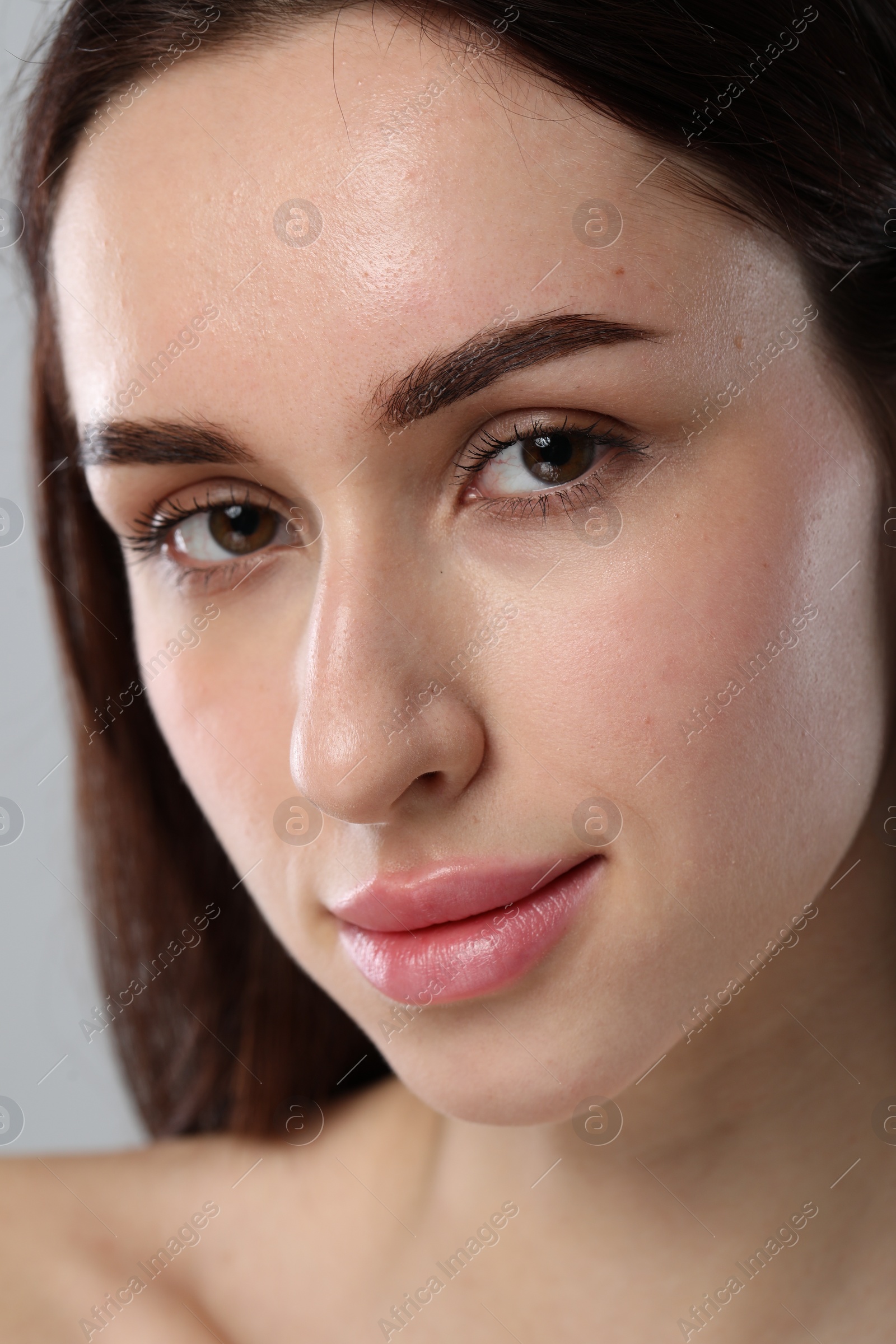 Photo of Beautiful young woman with healthy skin on light grey background, closeup