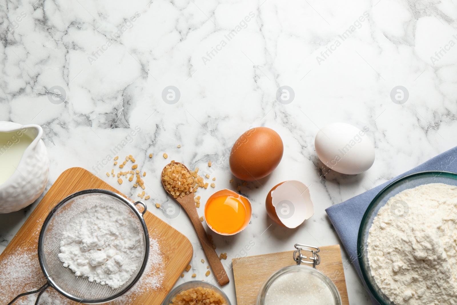 Photo of Flat lay composition with fresh ingredients for delicious homemade cake on white marble table. Space for text