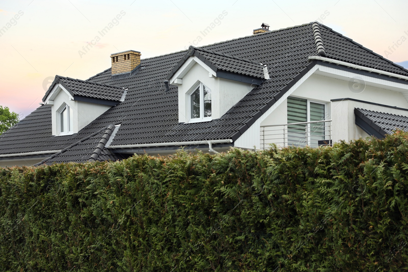 Photo of Modern building with grey roof outdoors on spring day