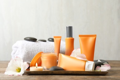 Composition with cosmetic products on wooden table