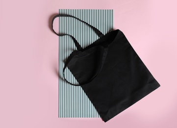 Flat lay composition with eco tote bag on color background. Space for design
