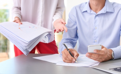 Tax accountants working with documents at table