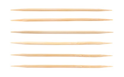 Set with wooden toothpicks on white background