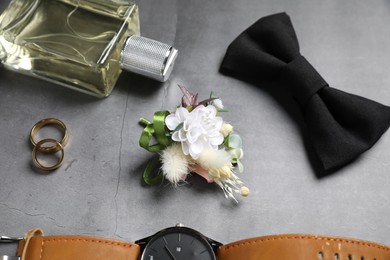Wedding stuff. Composition with stylish boutonniere on gray background