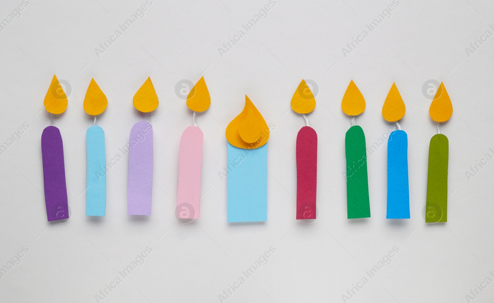 Photo of Different paper candles on white background, flat lay