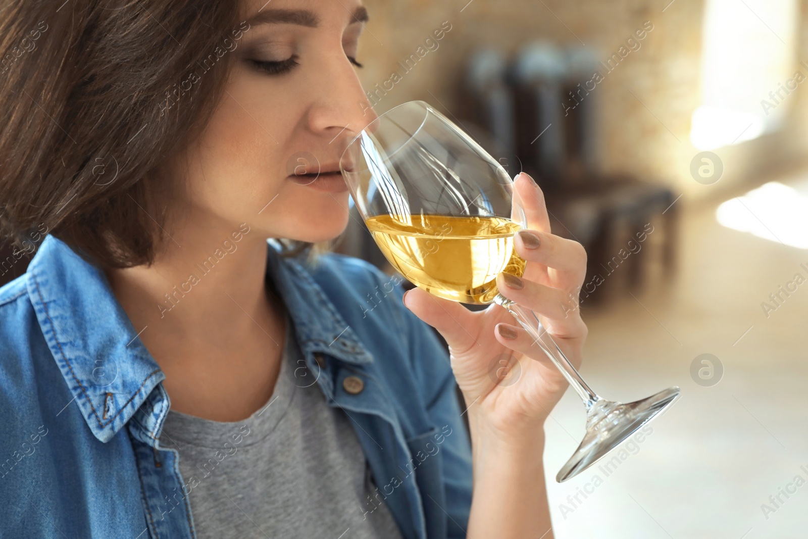 Photo of Woman with glass of white wine indoors, closeup