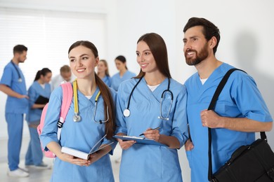 Photo of Medical students wearing uniforms in university hallway
