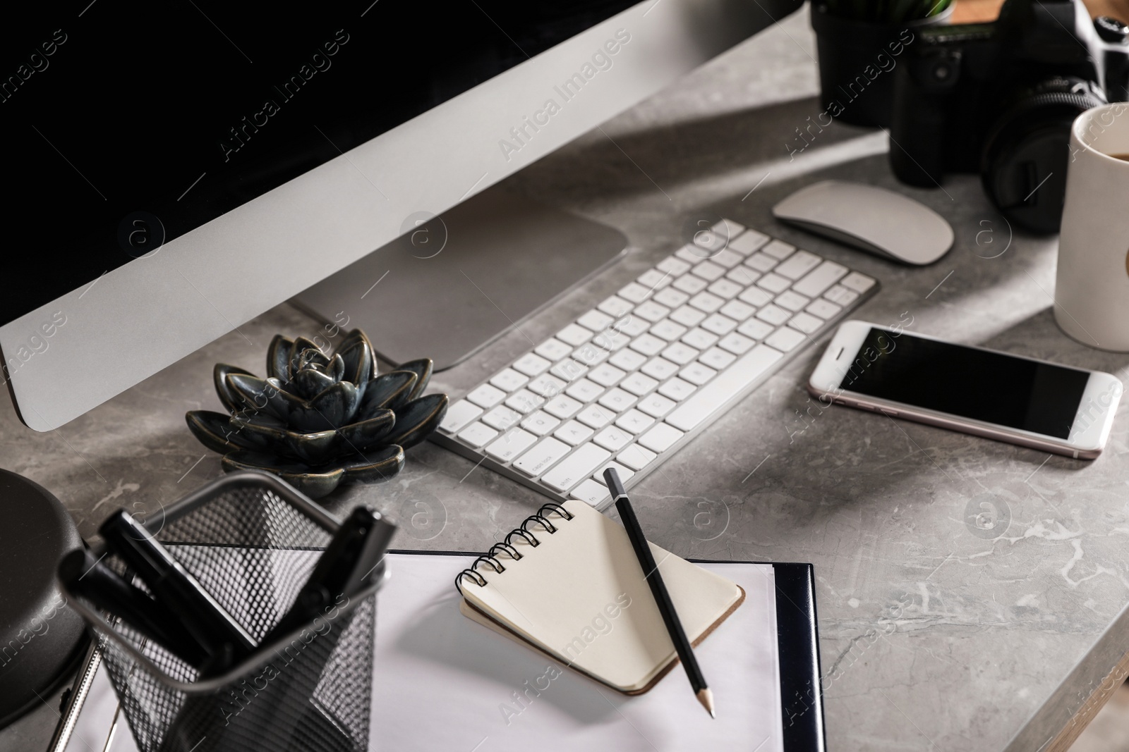 Photo of Designer's workplace with modern computer and camera