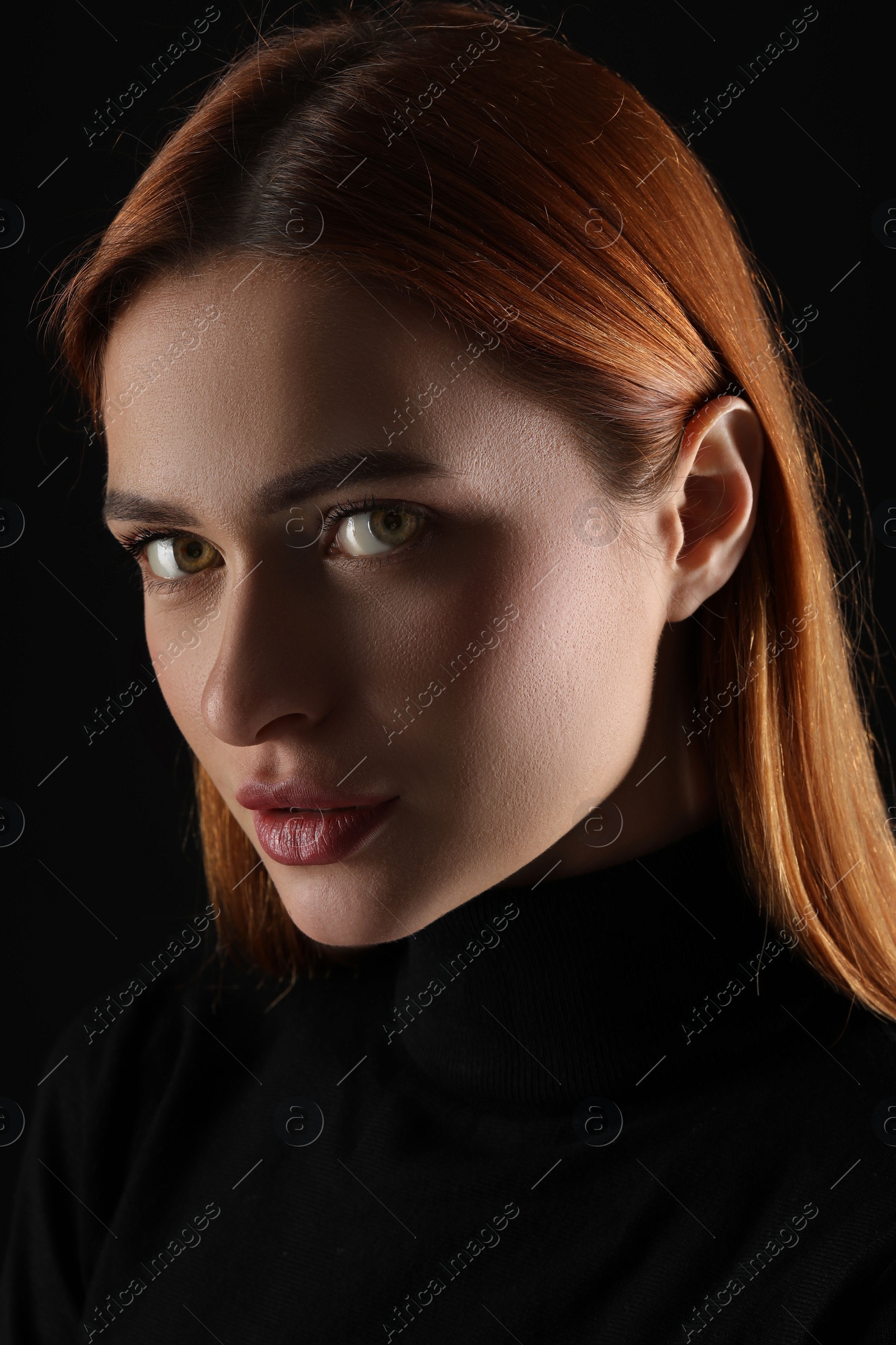 Photo of Evil eye. Young woman with scary eyes on black background