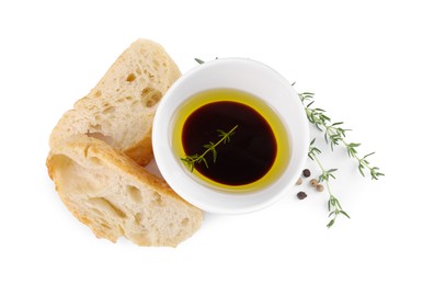 Photo of Bowl of organic balsamic vinegar with oil and spices served with bread slices isolated on white, top view