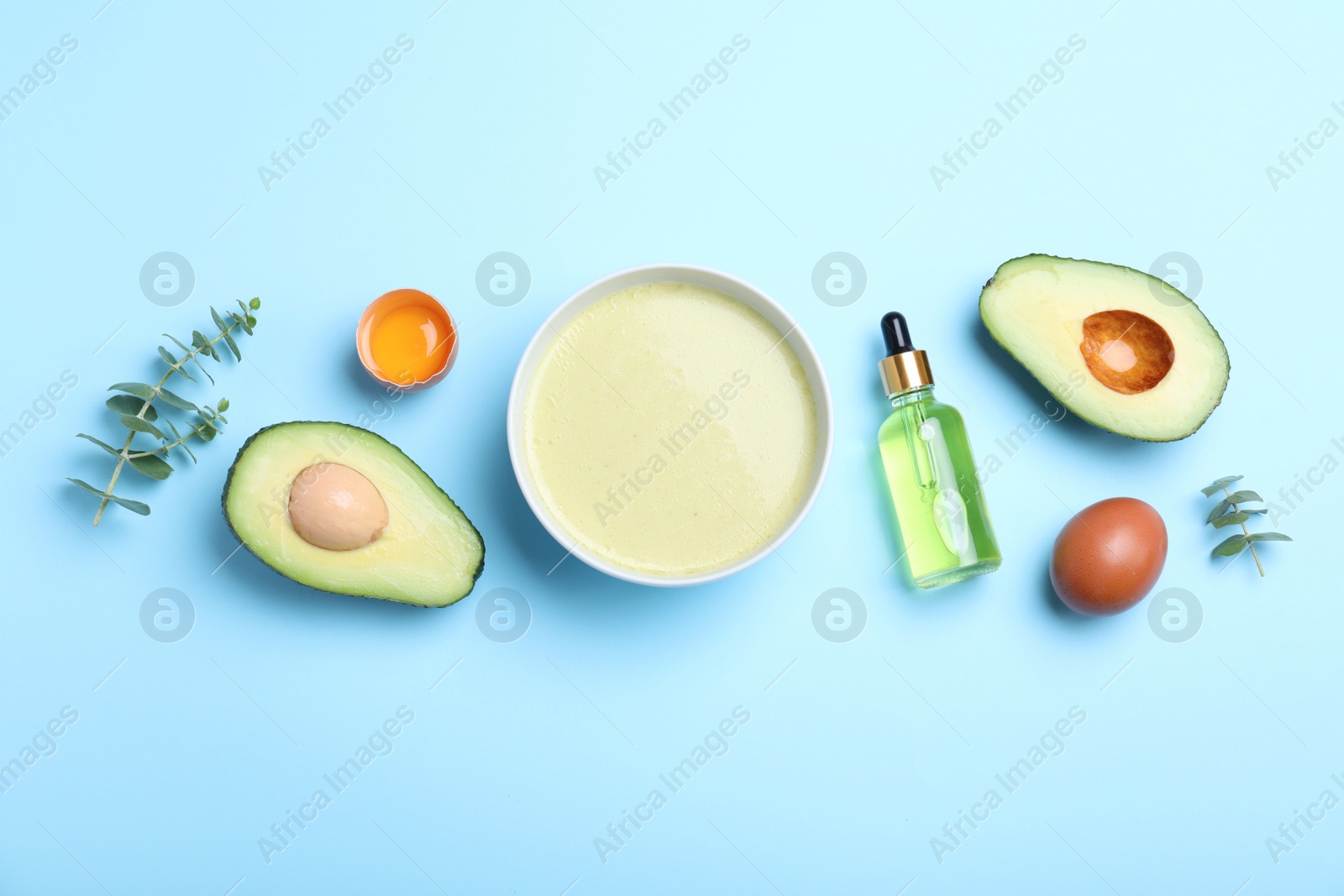 Photo of Homemade hair mask and ingredients on light blue background, flat lay