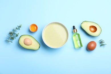 Homemade hair mask and ingredients on light blue background, flat lay