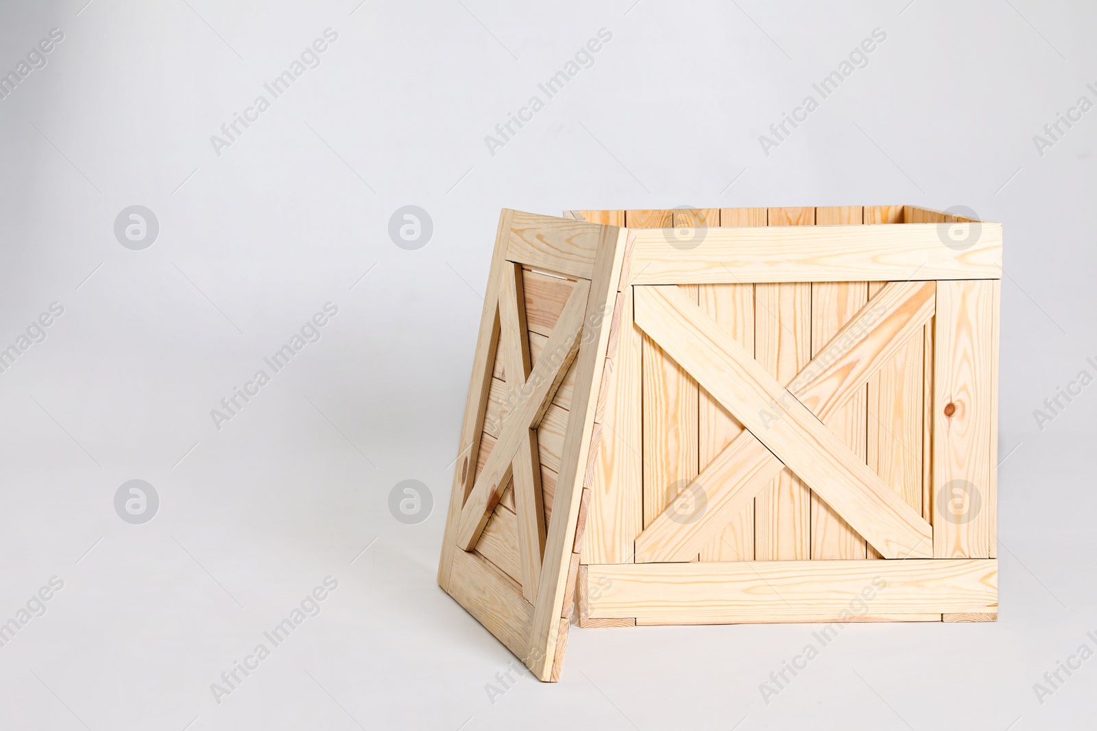 Photo of Open wooden crate on grey background. Space for text