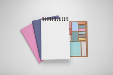 Monthly planners and stationery on white background, flat lay