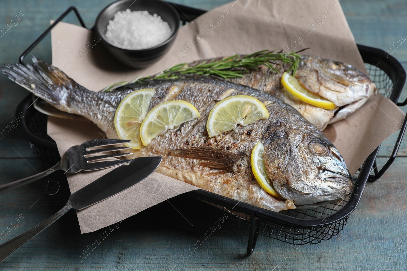 Photo of Delicious baked fish served on wooden rustic table, closeup. Seafood