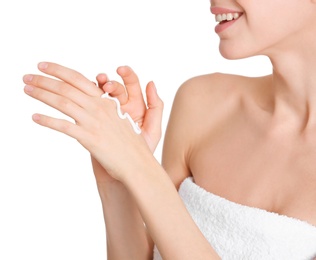 Photo of Young woman applying hand cream on white background