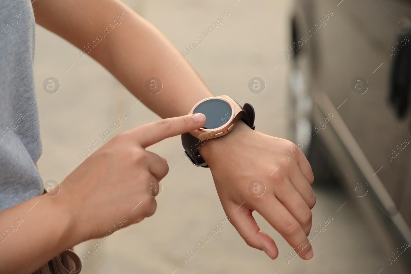 Photo of Young woman with smart watch outdoors, closeup