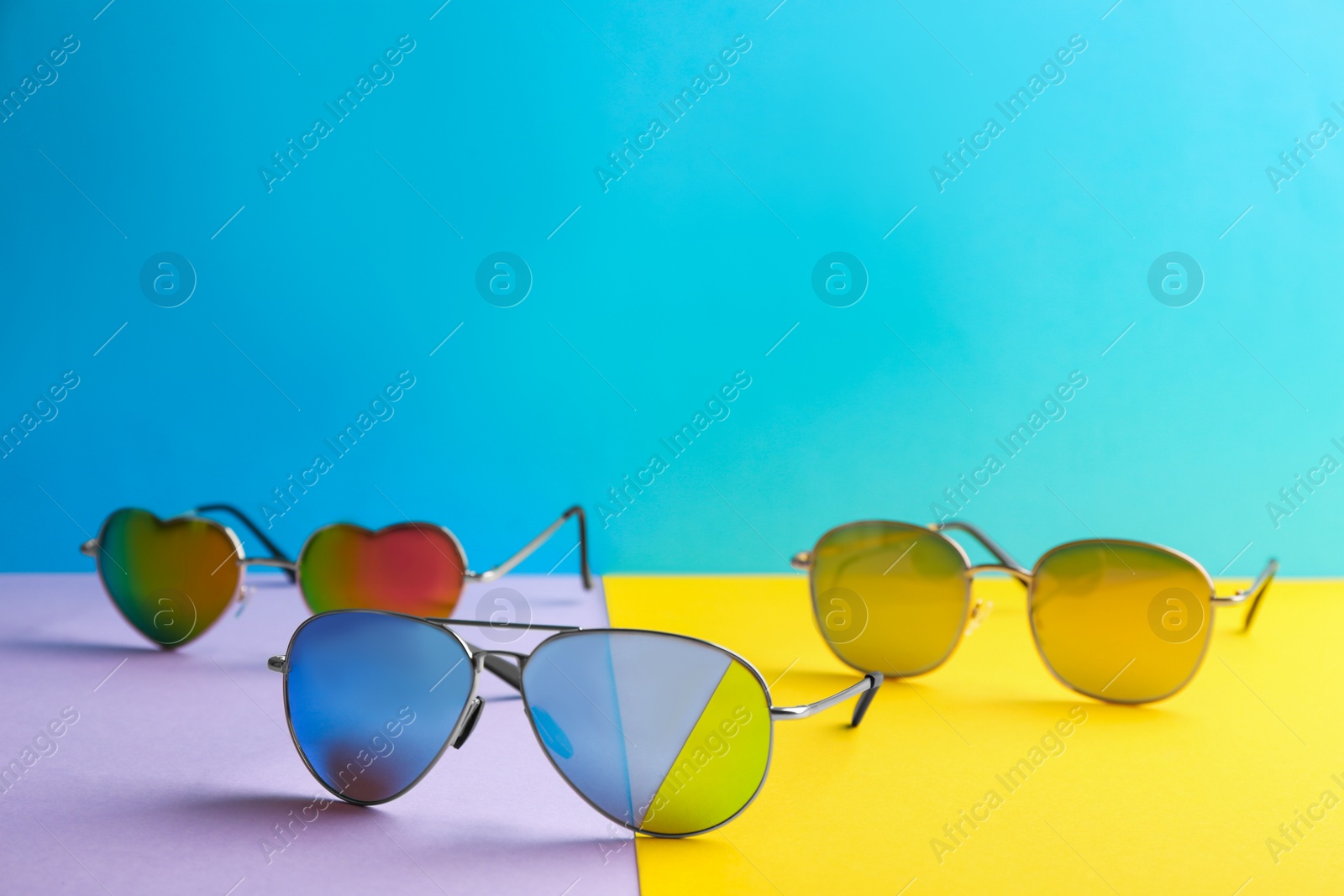 Photo of Stylish sunglasses on color background, space for text. Summer time