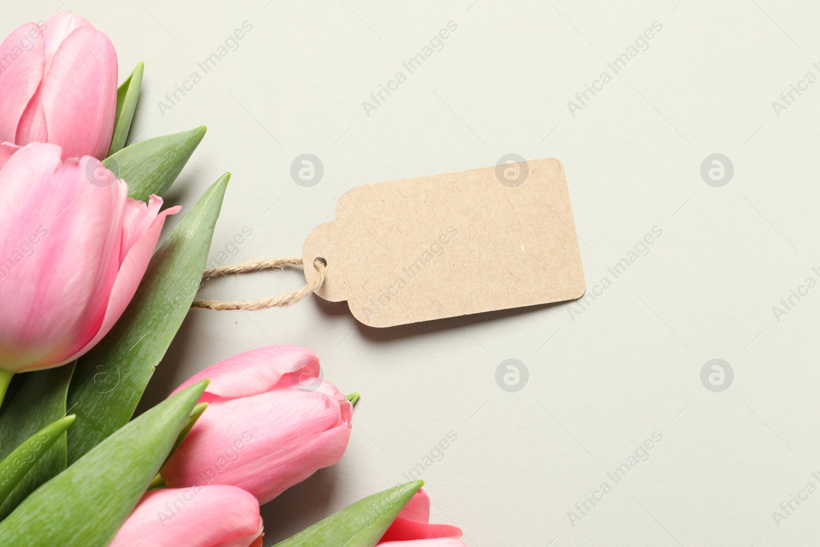 Photo of Happy Mother's Day. Beautiful flowers with blank card on light background, flat lay