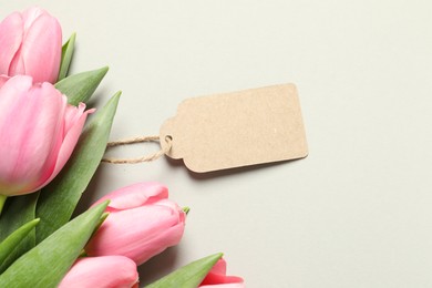 Happy Mother's Day. Beautiful flowers with blank card on light background, flat lay