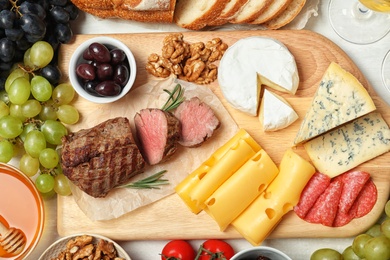 Photo of Flat lay composition with snacks for wine on white background