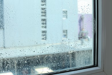 Photo of Window glass with water drops, closeup. Condensation