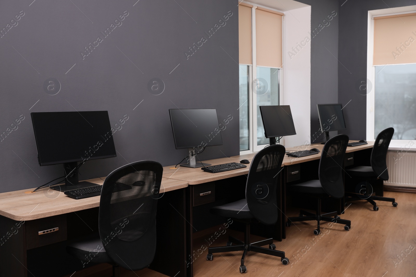 Photo of Many modern computers in open space office