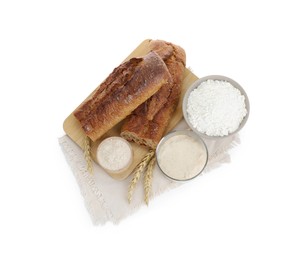 Photo of Freshly baked bread, sourdough, flour and spikes on white background, top view