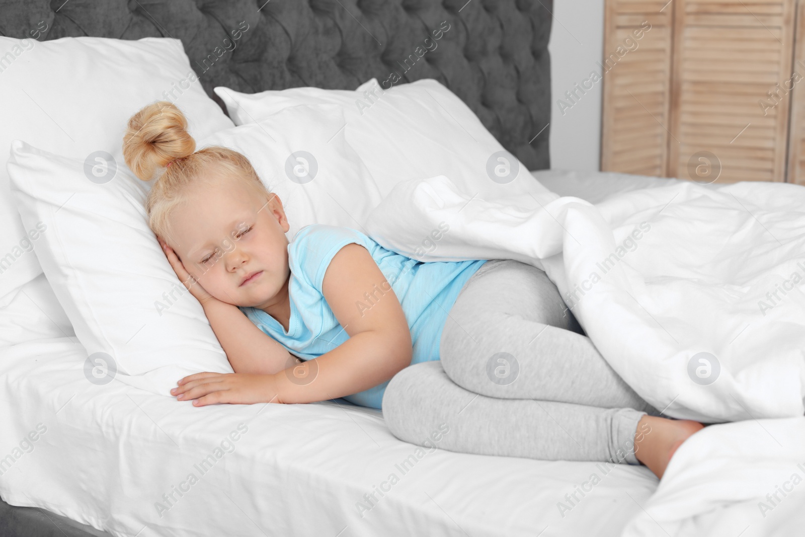 Photo of Cute little girl sleeping in bed. Nap time