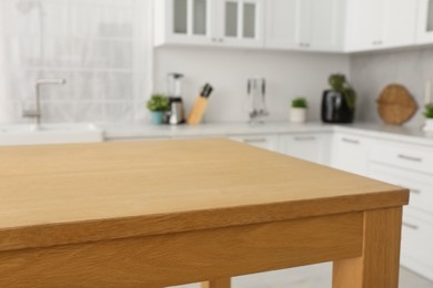 Stylish wooden table in kitchen. Interior design