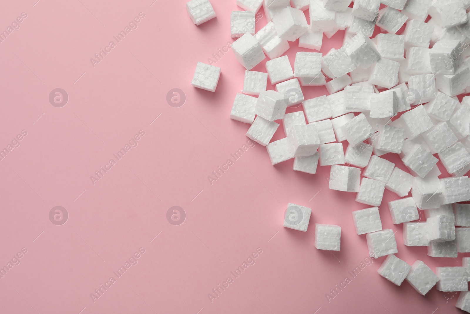 Photo of Many styrofoam cubes on pink background, flat lay. Space for text