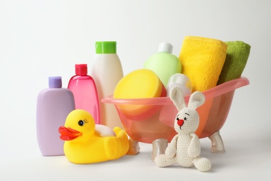 Photo of Baby bathing accessories, cosmetic products and toys on white background