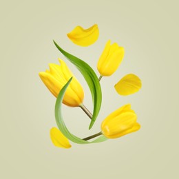 Image of Beautiful yellow tulips flying on light background