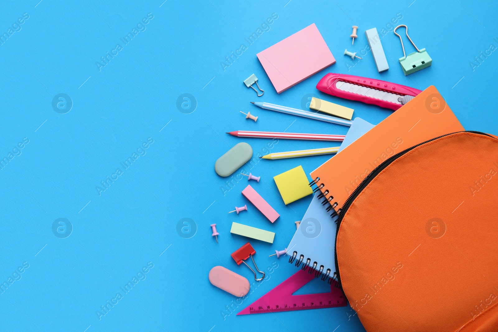 Photo of Different school stationery on light blue background, flat lay with space for text. Back to school