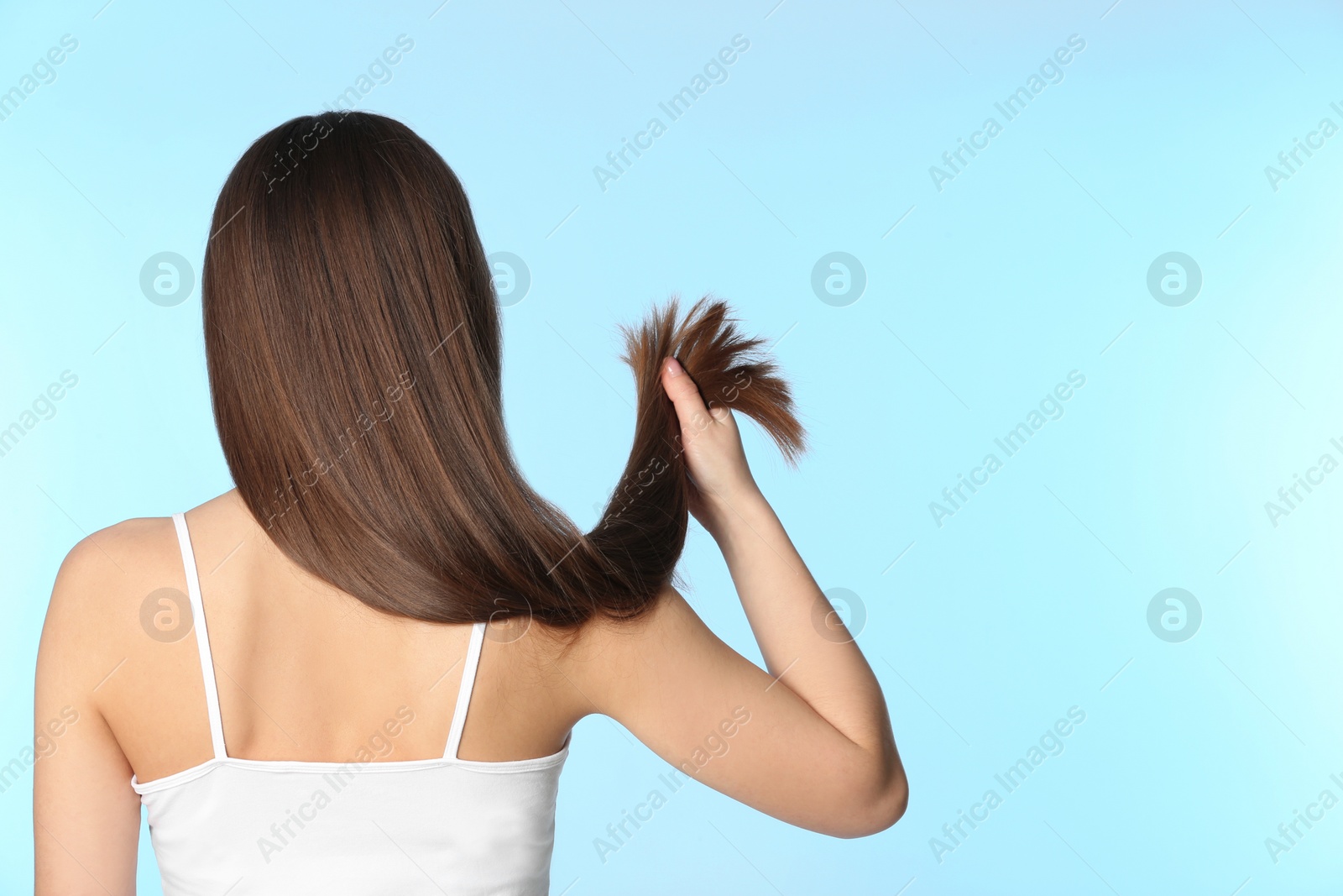 Photo of Woman with long brown hair on color background. Space for text