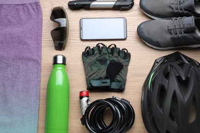 Photo of Flat lay composition with different cycling accessories on wooden background