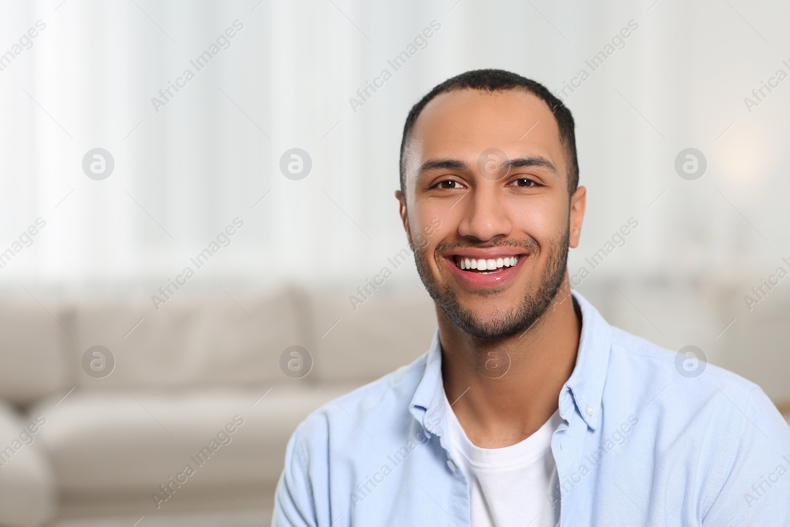 Photo of Portrait of smiling African American man at home. Space for text