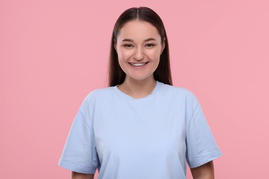 Photo of Smiling woman with dental braces on pink background