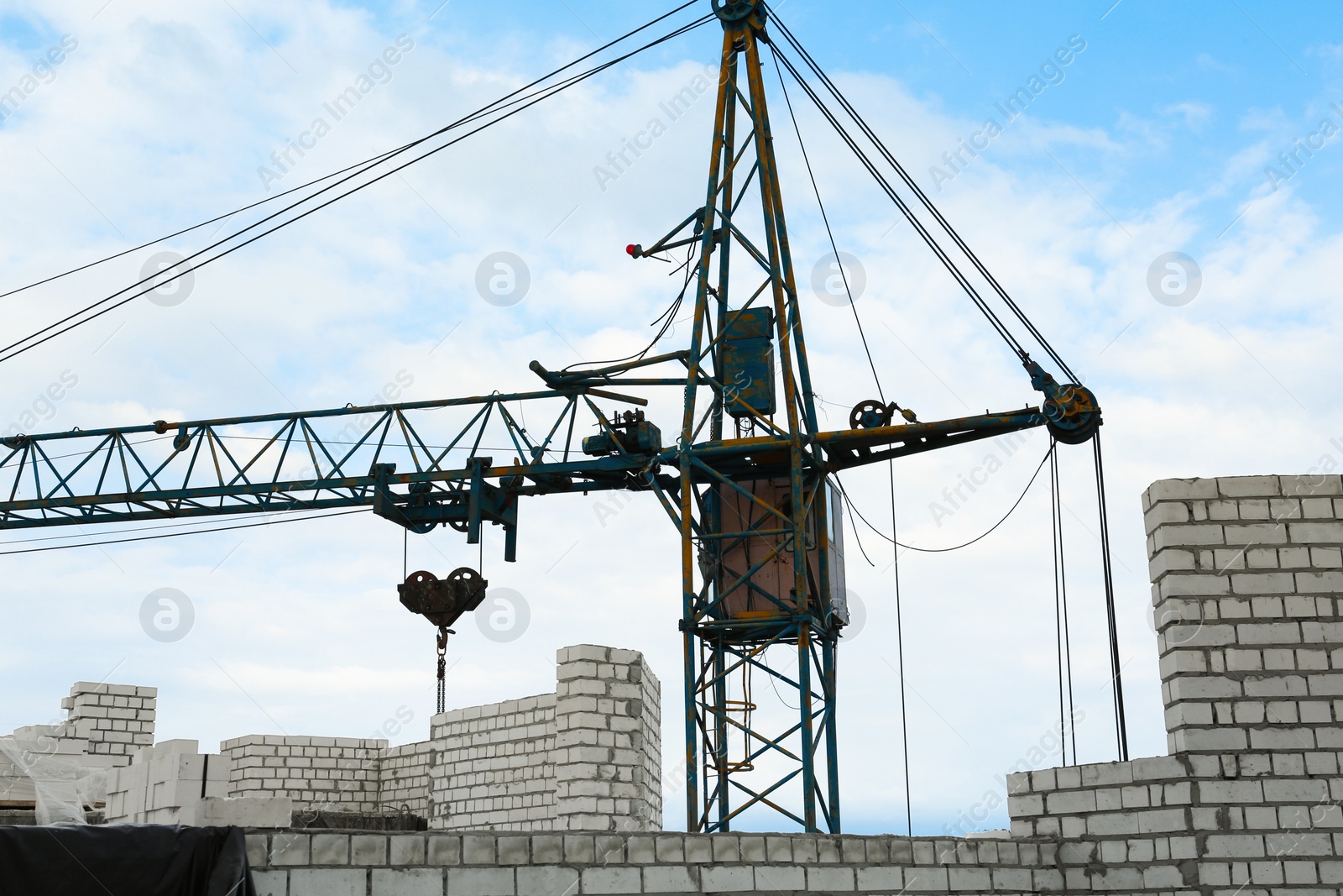 Photo of Construction site with tower crane near unfinished building