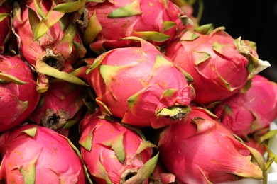 Photo of Pile of delicious fresh ripe pitahayas, closeup