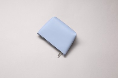 Photo of One cosmetic bag on beige background, top view