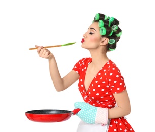 Photo of Funny young housewife with spoon and frying pan on white background