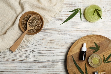 Photo of Flat lay composition with hemp lotion on wooden background