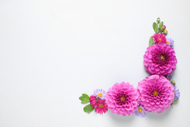 Photo of Flat lay composition with beautiful dahlia flowers and space for design on white background