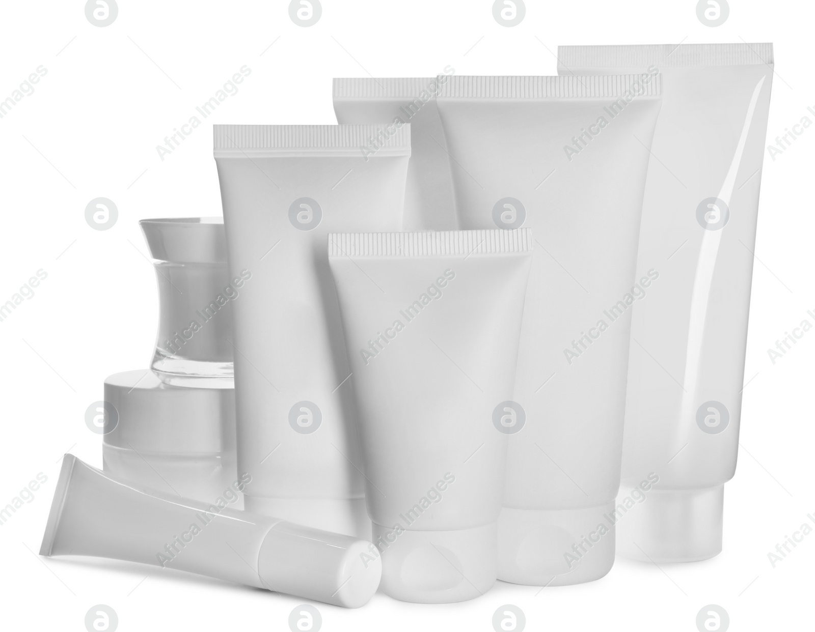 Photo of Blank tubes and jars of cosmetic products on white background